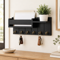 Black wooden key holder with mail shelf and six hooks on an entryway wall above an oak console