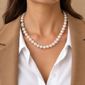 Classic freshwater pearl strand necklace worn with a white shirt and camel blazer